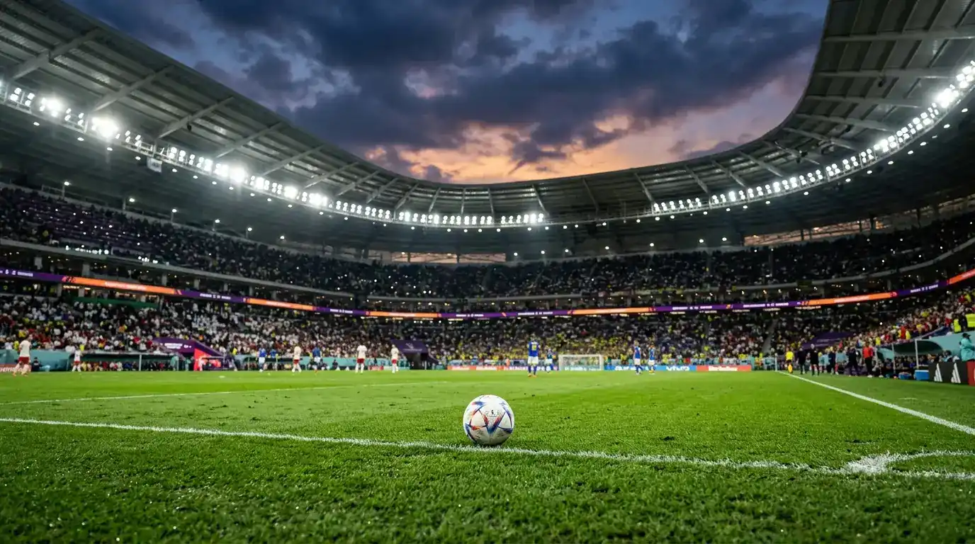 A floodlit World Cup knockout night, silhouetted fans in the stands with flags raised, a soccer ball on the pitch in sharp focus